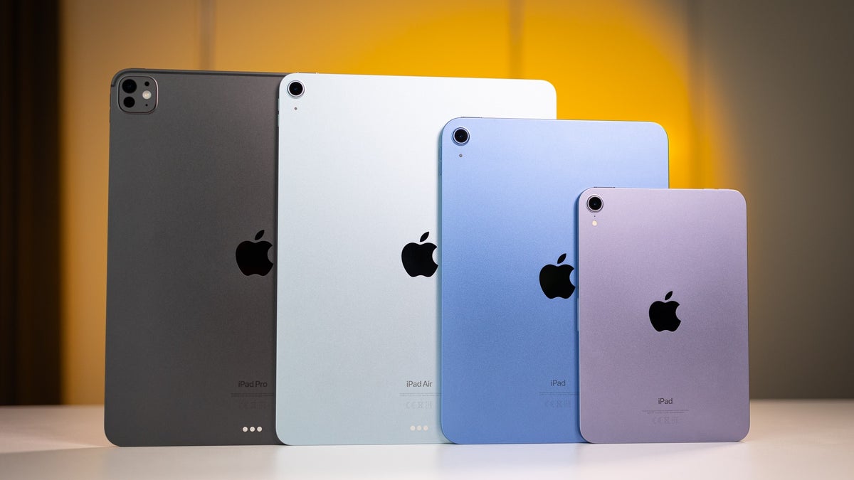 iPad Pro, iPad Air, iPad, and iPad mini models on a white table, showcasing their rear design.