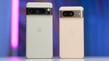 Pixel 8 Pro and Pixel 8 are placed on a table, showcasing their iconic camera bar on the back and the Google logo.