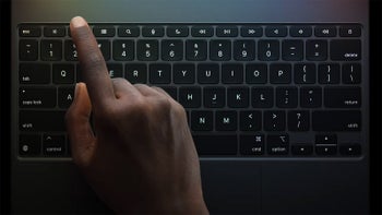 A person's hand typing on an iPad Magic Keyboard