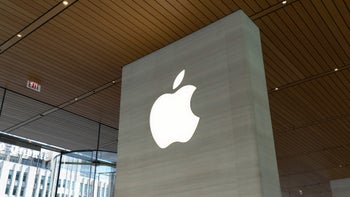 Apple's logo displayed on a gray wall.