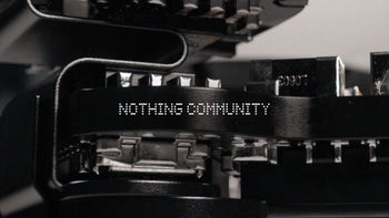 Image of manufacturing machinery blurred in background with the words "Nothing Community" in the foreground