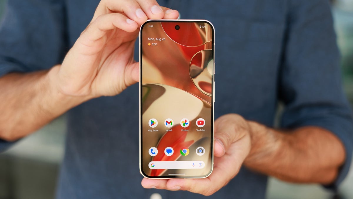 A person holding and showing the front screen of a Google Pixel 9 Pro XL