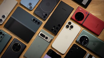 A group of smartphones on a table.