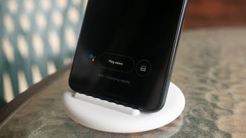 An image of a Pixel smartphone standing on a charger with the words "charging rapidly" displayed