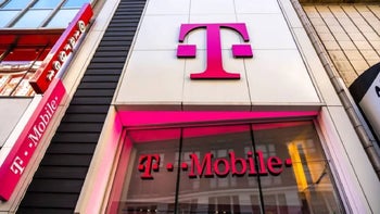 The T-Mobile "T" logo in magenta is mounted on white tiles on a storefront.