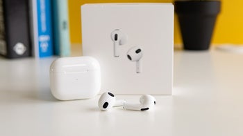 AirPods 3 and their charging case in front of their retail box.