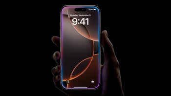 An iPhone 16 Pro showing the home screen is held by a right hand against a black backdrop.