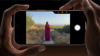 A close-up that shows two hands holding the iPhone 16 Pro and taking a picture with it in landscape mode.