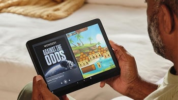 A person holding the Fire HD 10 (2023) with the display turned on