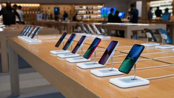 iPhones on a table display in an Apple Store.