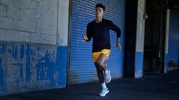 A person running while wearing a Garmin Forerunner 265 on their left wrist