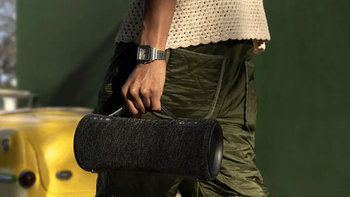 A person carrying the Sony SRS-XG300 by its built-in strap