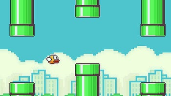 A screengrab of the Flappy Bird game shows the titular bird flying between the pipes.