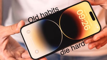 An iPhone 14 Pro Max with the phrase "Old habits die hard"