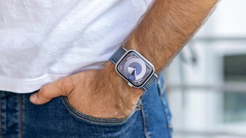 Apple Watch Series 9 in blue band worn on a man's wrist.