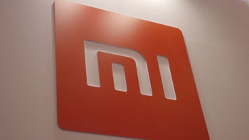 Xiaomi logo showcased on a wall.