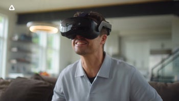 A man excitedly using an HTC Vive Focus Vision