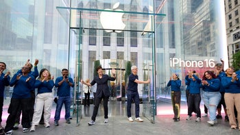 Apple CEO Tim Cook holds open the door that leads consumers to the Fifth Avenue Apple Store in New York City.