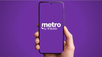 Phone displaying Metro by T-Mobile logo is held up against a purple backdrop.