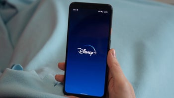 Disney logo displayed on a smartphone held in a person's hand.