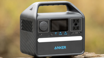 Anker Solix 521 power station with a turned-on light strip, placed against a blurred background in a natural setting.