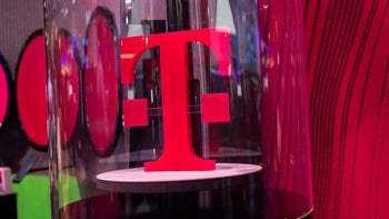 The iconic T-Mobile "T" icon is inside a glass enclosure sitting on a circular platform.