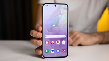 A person holding the Galaxy A35 with the screen turned on