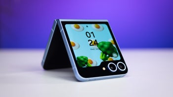 Galaxy Z Flip 6, placed half-opened on a white table, showcasing animations on the external display.