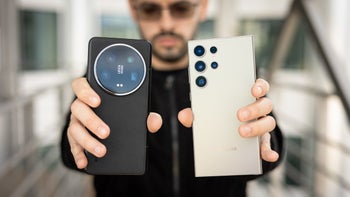 A person holding the Xiaomi 14 Ultra in one hand and the Galaxy S24 Ultra in the other in front of his face.