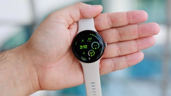 An image of a person's hand hold up a Google Pixel Watch