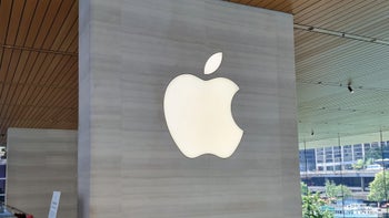 Apple logo displayed over a grey wall.