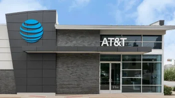 An AT&T store with the carrier's "ball" logo is seen with a beautiful blue sky in the background.