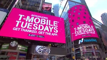 Digital signs in magenta promote T-Mobile 's reward program T-Mobile Tuesdays.