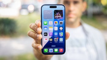 PhoneArena's Vic is holding up the front of an iPhone 16 to the camera.