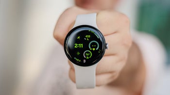 The Google Pixel Watch 3 held in a person's hand towards the viewer.