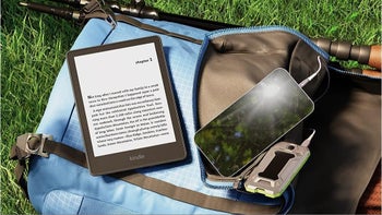 Kindle e-reader in a backpack with a smartphone and other items.