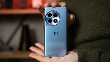 A person gently holding the OnePlus 12.