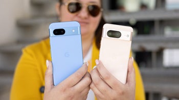 The Pixel 8a and the Pixel 8 in person's hands next to each other.