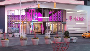 A T-Mobile store is open for business with magenta signs and a magenta interior.