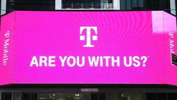 A bill board with the T-Mobile "T"-icon asks "Are You With Us?" in white against a magenta backdrop.