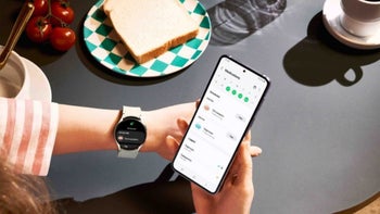 A person with a Galaxy Watch and Galaxy phone looking at the Samsung Health app.