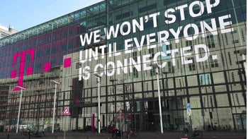 A sign shows the magenta "T" T-Mobile logo on the left with the words "We won't stop until everyone is connected" on the right.