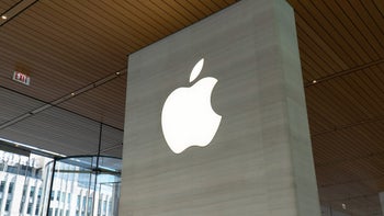 The image shows the exterior of an Apple Store, with the iconic Apple logo prominently displayed.