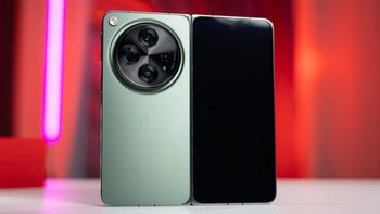 The OnePlus Open smartphone unfolded, showing its dual screens and circular camera module.