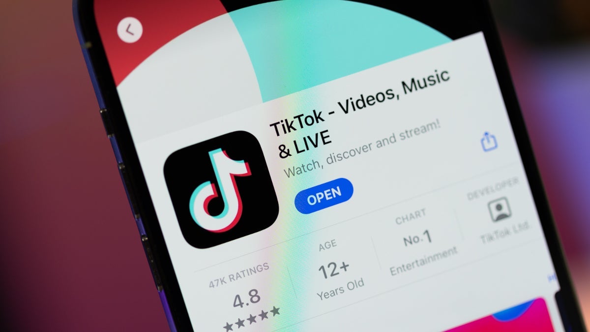 A phone with the TikTok app on its screen.