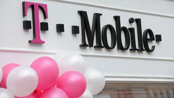 A sign above the doors of a T-Mobile store shows the carrier's trademark including the iconic magenta "T."