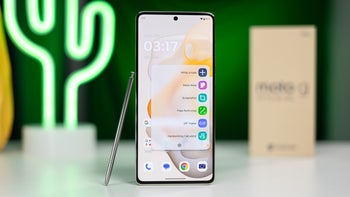 Moto G Stylus 5G (2024) in Caramel Latte, with its stylus placed by its right side, showcased against a blurred background.