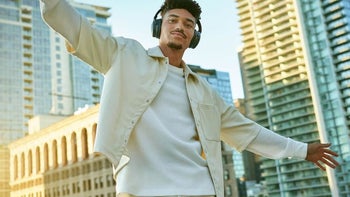 A person wearing Bose QuietComfort headphones, enjoying music.