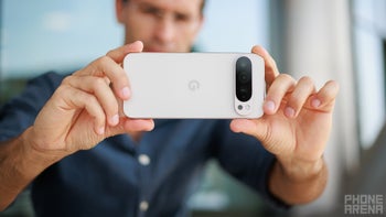 A person holding a Pixel phone to take a photo.