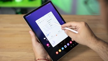 A person holding the Galaxy Tab S9 uses the S Pen to write notes on the Samsung Notes app.